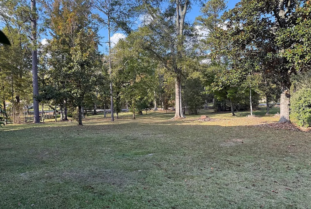 Double porch love! Pretty setting! On 16 acres in Alabama. $524,900