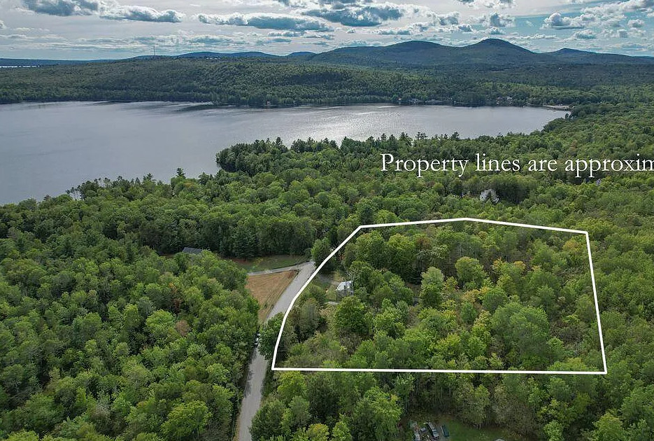 Knotty pine and stone! Circa 1904. Four acres in Maine. $315,000