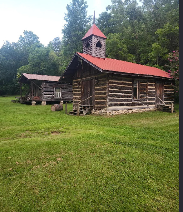 OMG! I want this village! That old chapel is so cool! Ten cabins on 22 acres in Kentucky. $350,000
