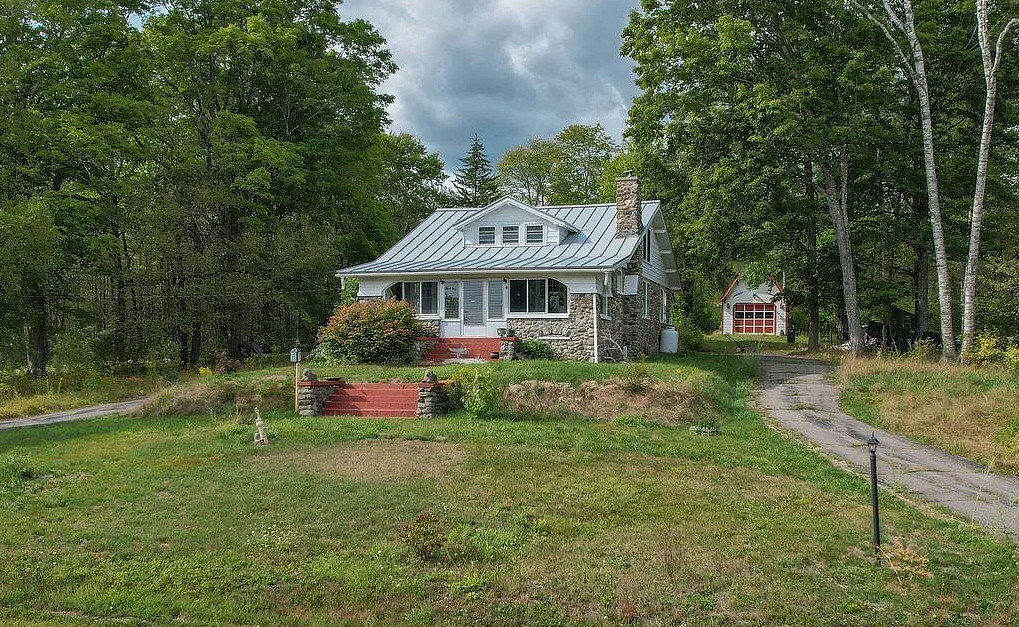 Knotty pine and stone! Circa 1904. Four acres in Maine. $315,000