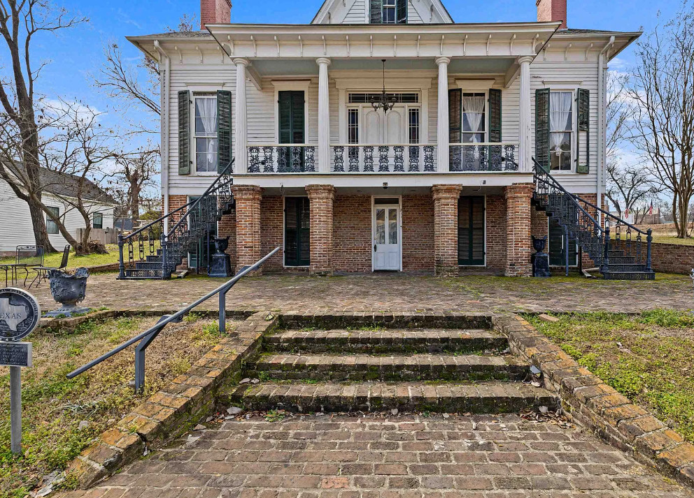 Interesting Greek Revival Raised Cottage in Texas! Love the brick flooring! $624,900