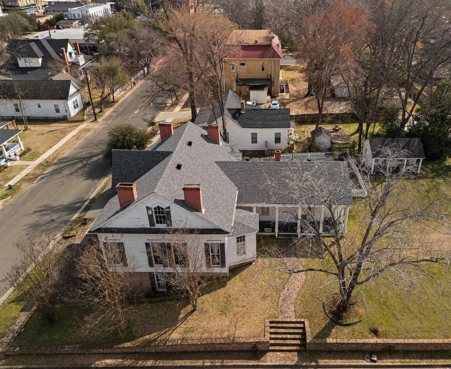Interesting Greek Revival Raised Cottage in Texas! Love the brick flooring! $624,900