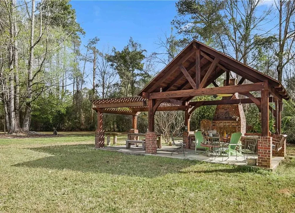 Nice outdoor fireplace! Citrus trees on the property. On 20 acres in Louisiana. $425,000