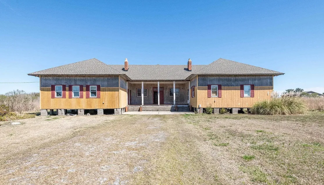30 minutes to the beach! Former school. Love the stage with original seating! Over two acres in NC. $375,000