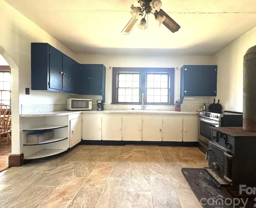 Stone cottage with rolled eaves! Over an acre in North Carolina. $225,000