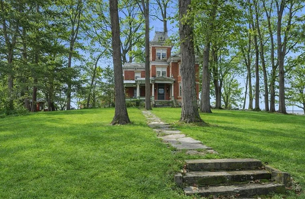 That staircase! I love this house and property! Over two acres in Missouri. $295,000