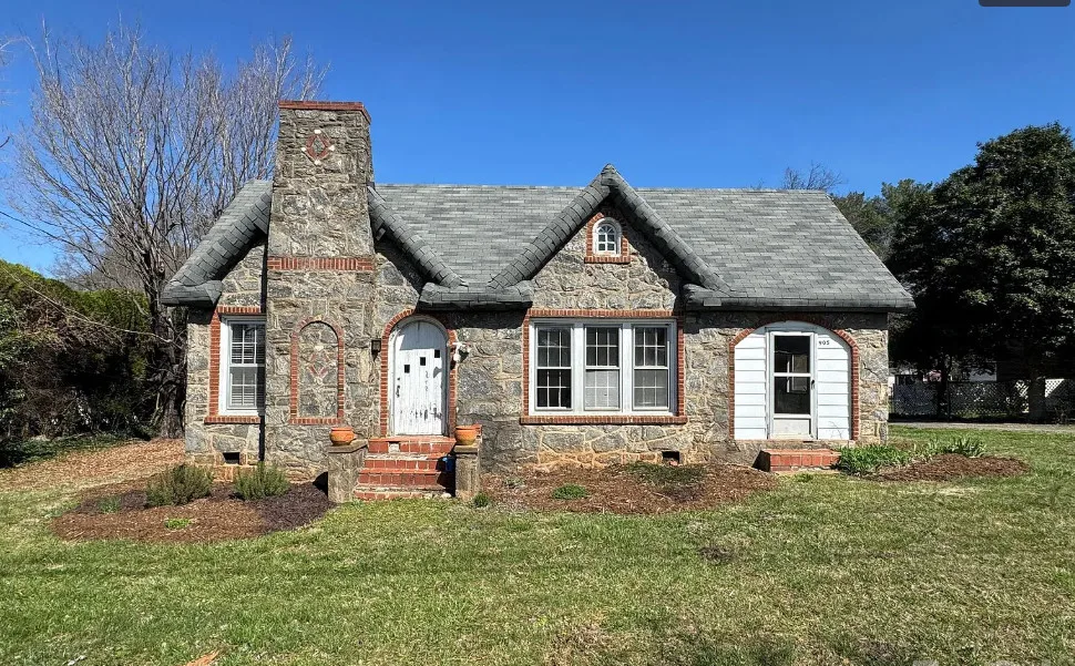 Stone cottage with rolled eaves! Over an acre in North Carolina. $225,000