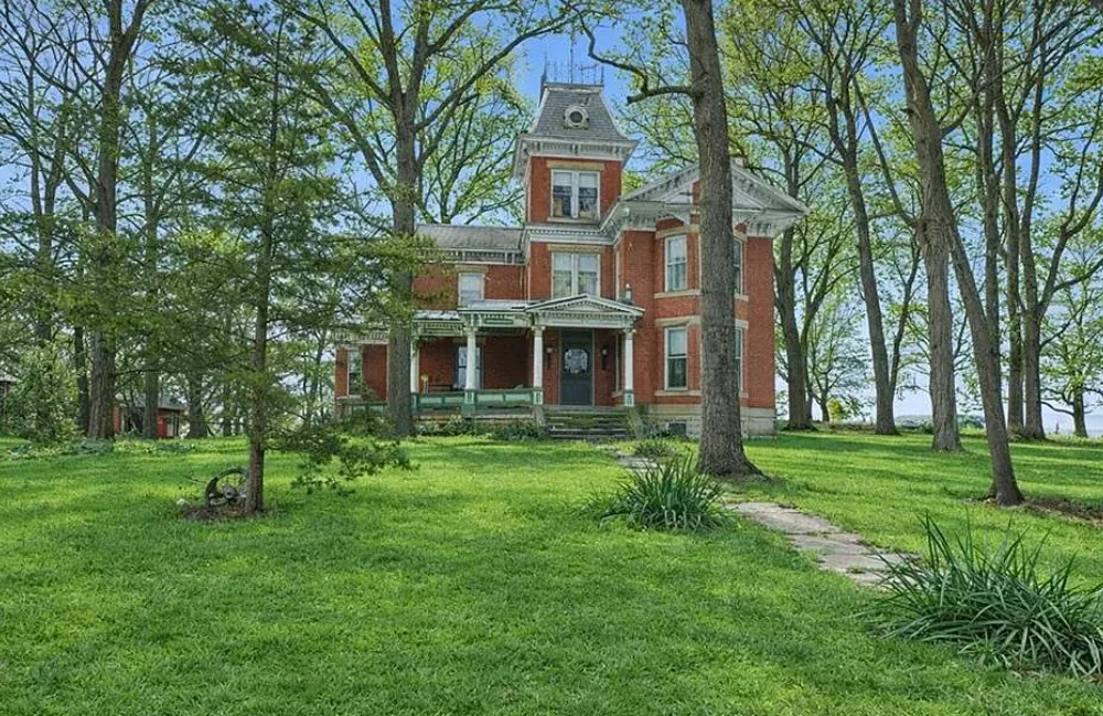 That staircase! I love this house and property! Over two acres in Missouri. $295,000