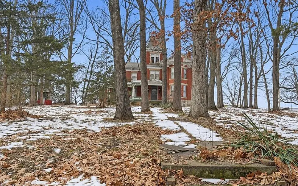 That staircase! I love this house and property! Over two acres in Missouri. $295,000