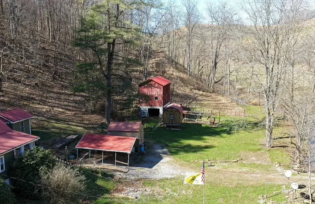 Pretty setting! On 66 acres in West Virginia. Has a creek.
