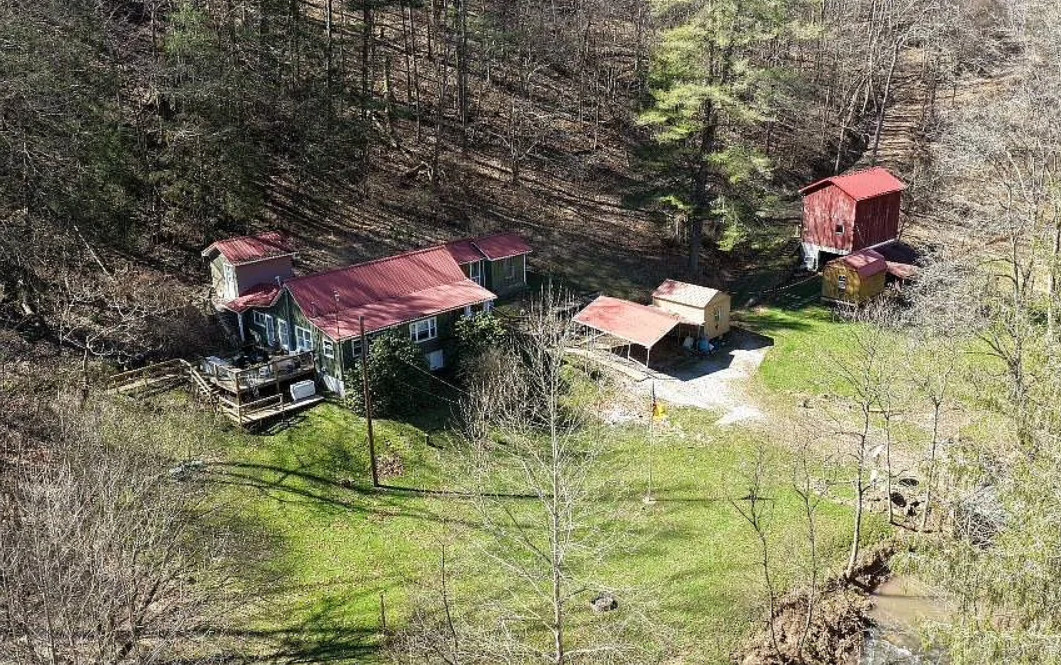 Pretty setting! On 66 acres in West Virginia. Has a creek.