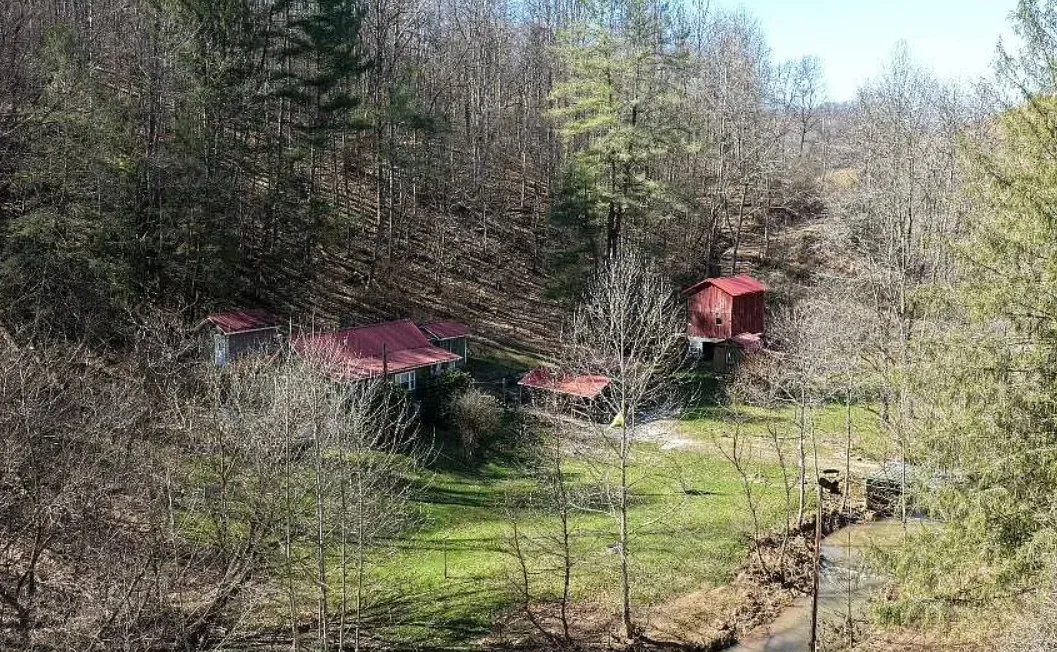 Pretty setting! On 66 acres in West Virginia. Has a creek.