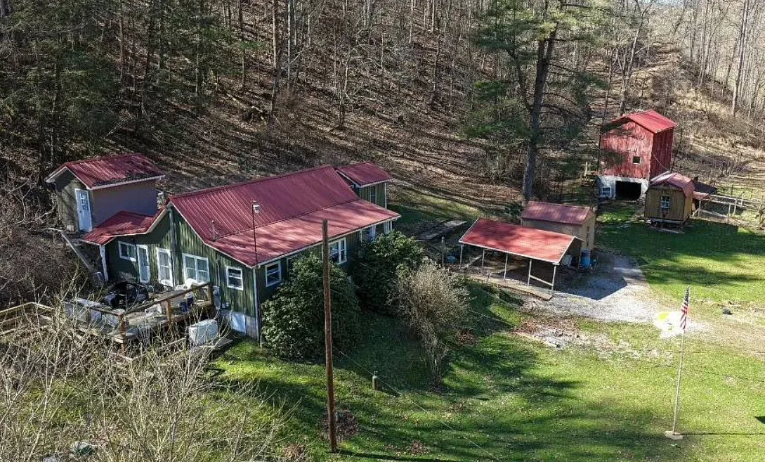 Pretty setting! On 66 acres in West Virginia. Has a creek.