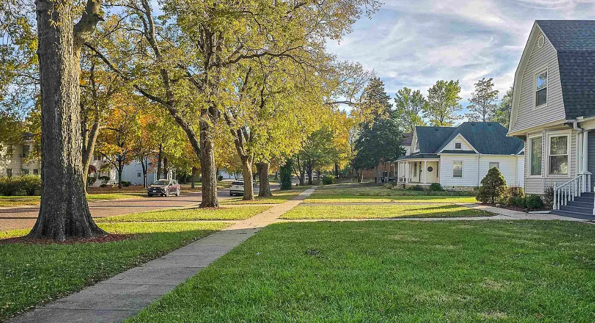 Unpainted woodwork! Pretty tree lined street! Circa 1910 in Kansas.