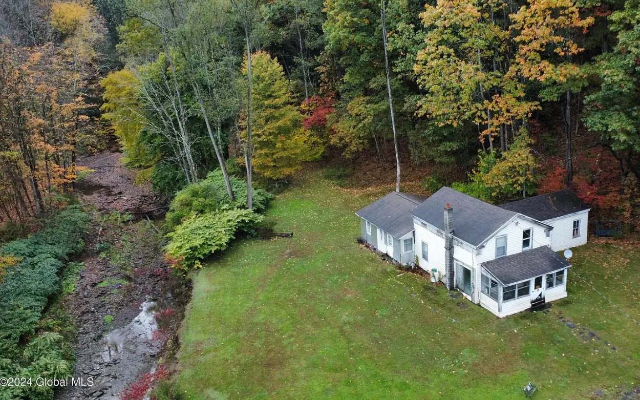 Charming 1890 Home on 9 Acres with Private Waterfall in Bainbridge, New York – $132,000